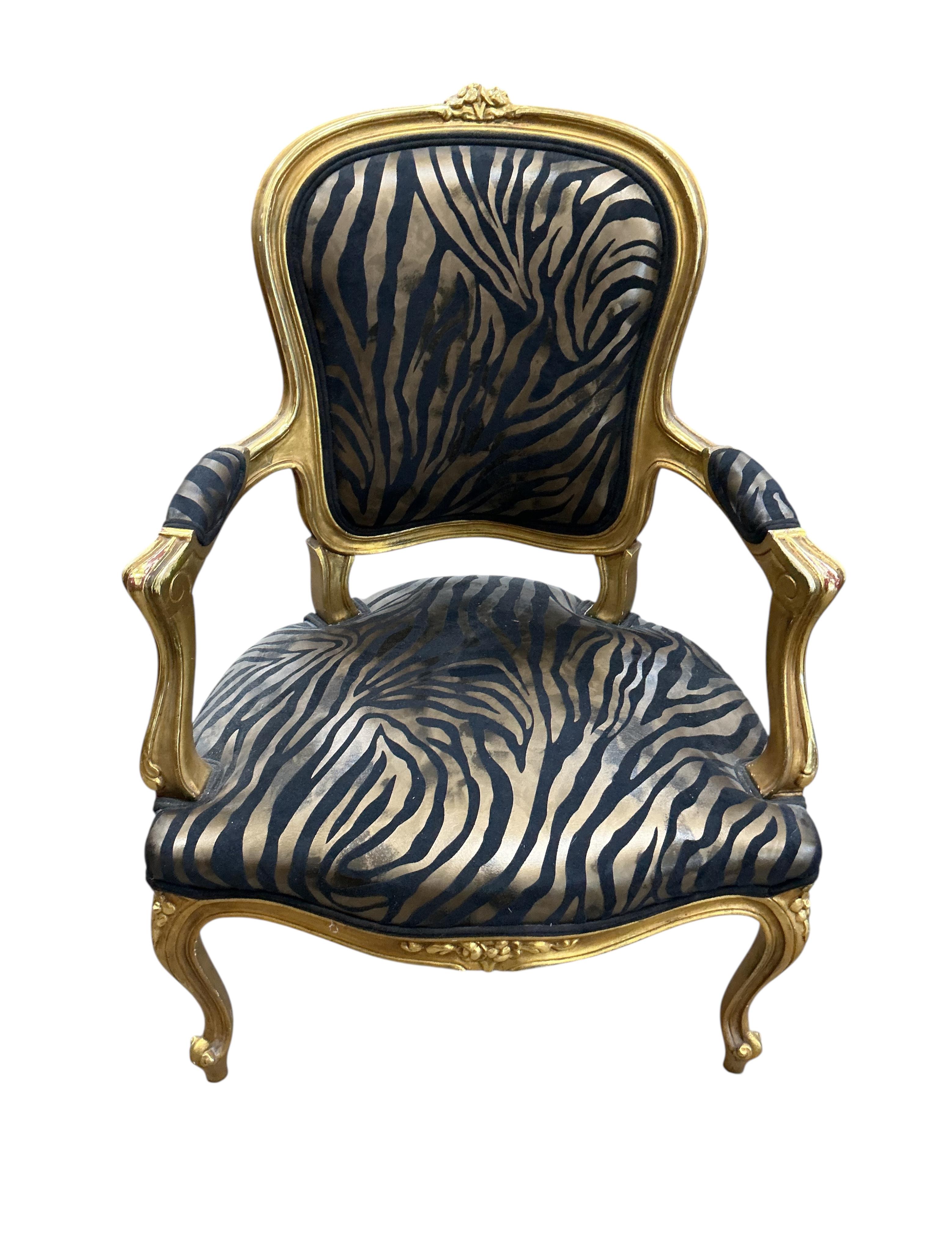 A pair of Louis XVI style fauteuil with faux zebra print upholstery, width 59cm, depth 46cm, height 92cm